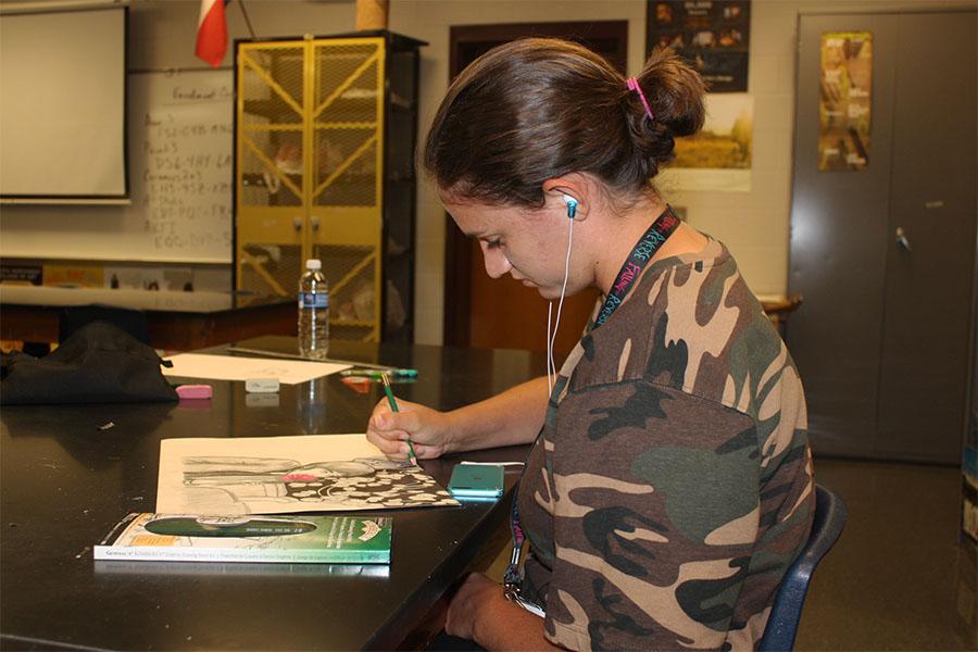 Junior Laura Winston works on an art project for AP Art 4. 
