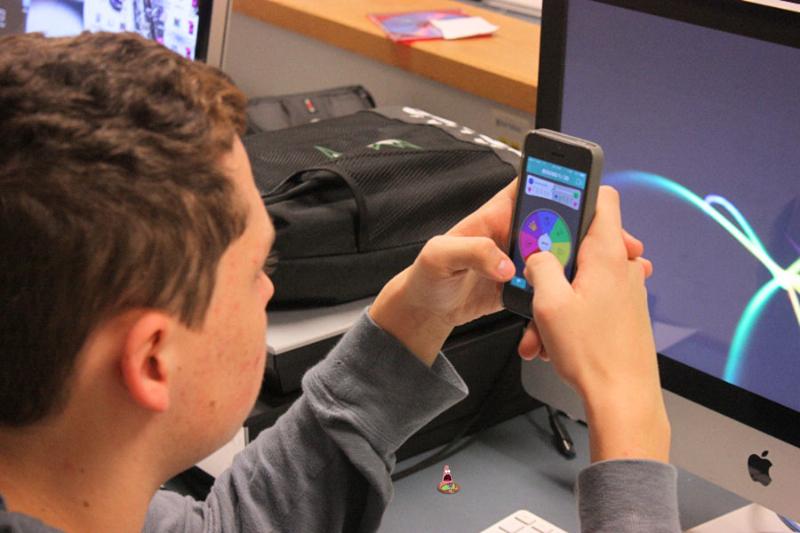 Junior Cameron Hancock plays Trivia Crack during a quiet moment in his yearbook class. 