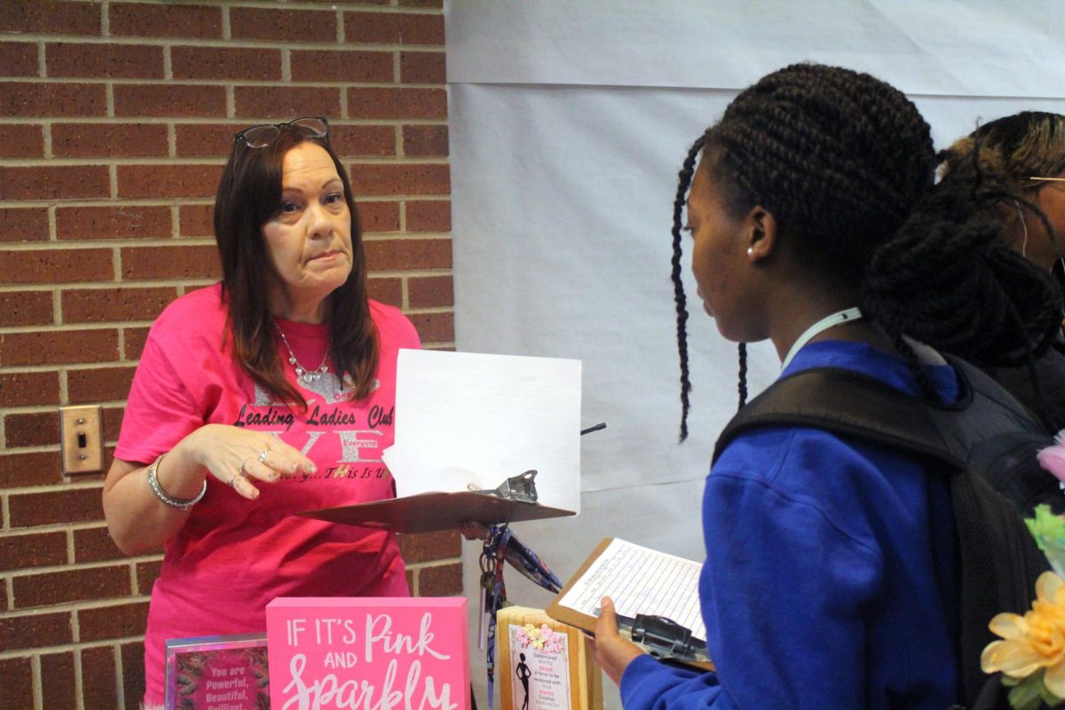 Ms. Barbour handing out flyers for Leading Ladies club. 