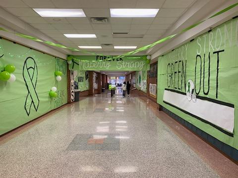 The cafeteria hallway decorated for green out.