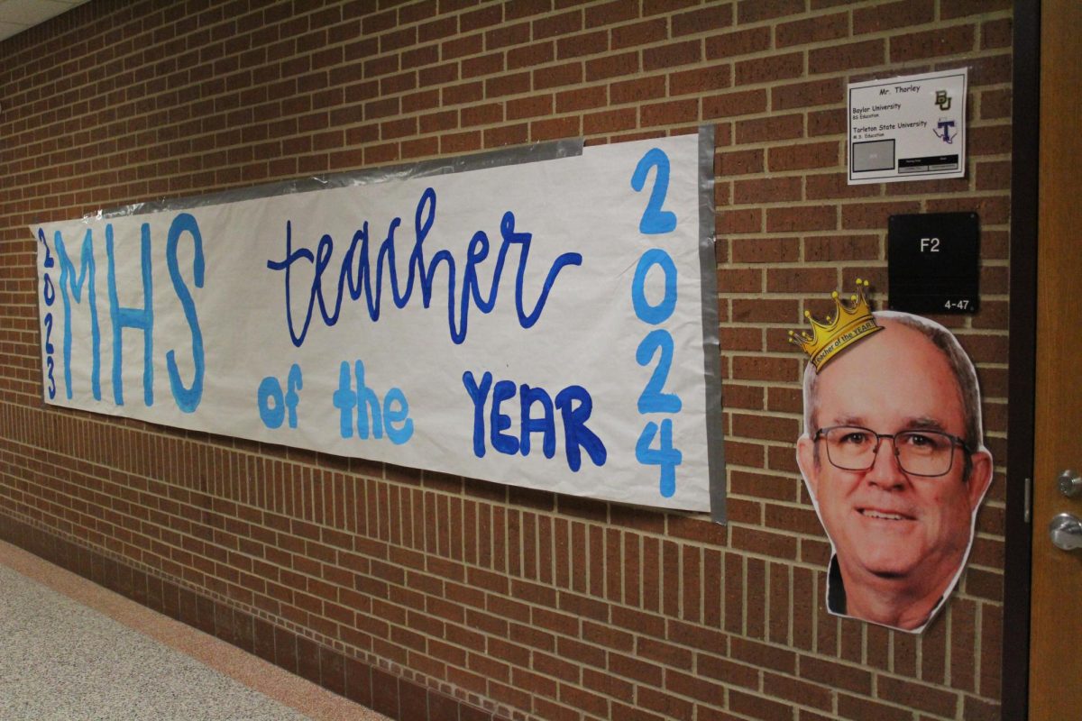 A 20 foot teacher of the year banner is next to Mr. Thorley's classroom