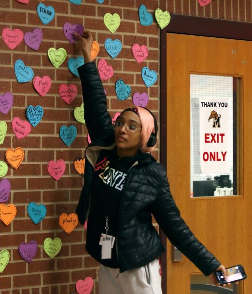 A junior grabs her heart off of the wall