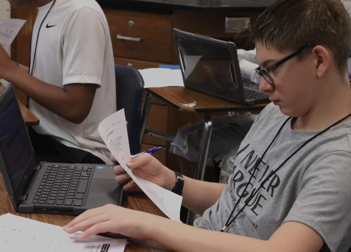 A freshman Biology student works on his paper.